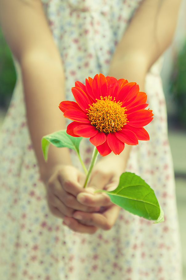 A young girl delivers flowers for you